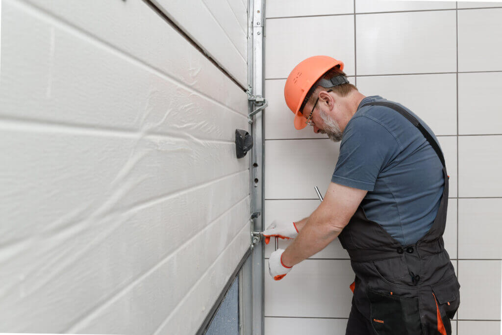 The worker is the lifting gates of the garage door repair.
